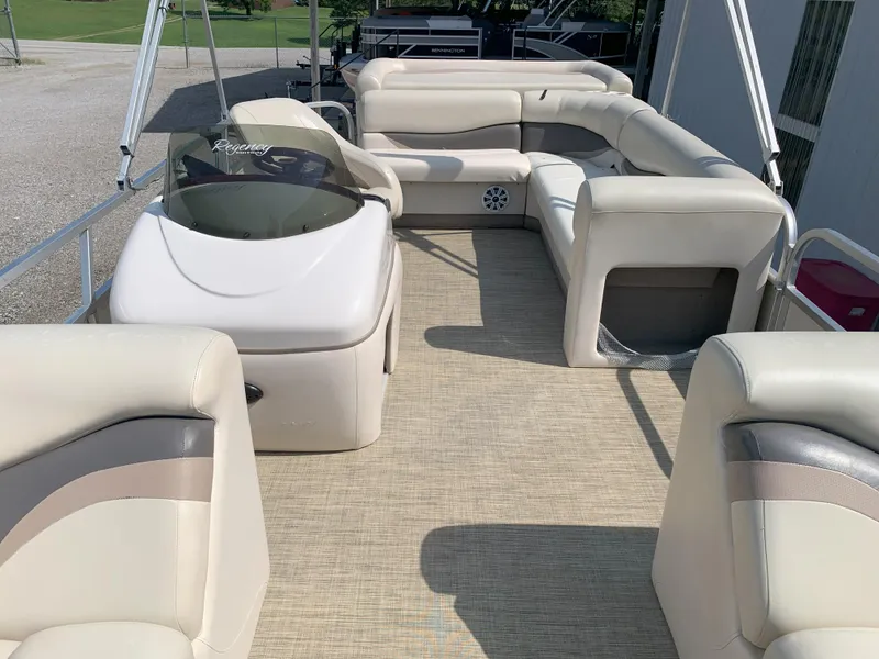 Slide: The Image of 2007 Sun Tracker Party Barge 22 interior with beige seating and helm. - 6