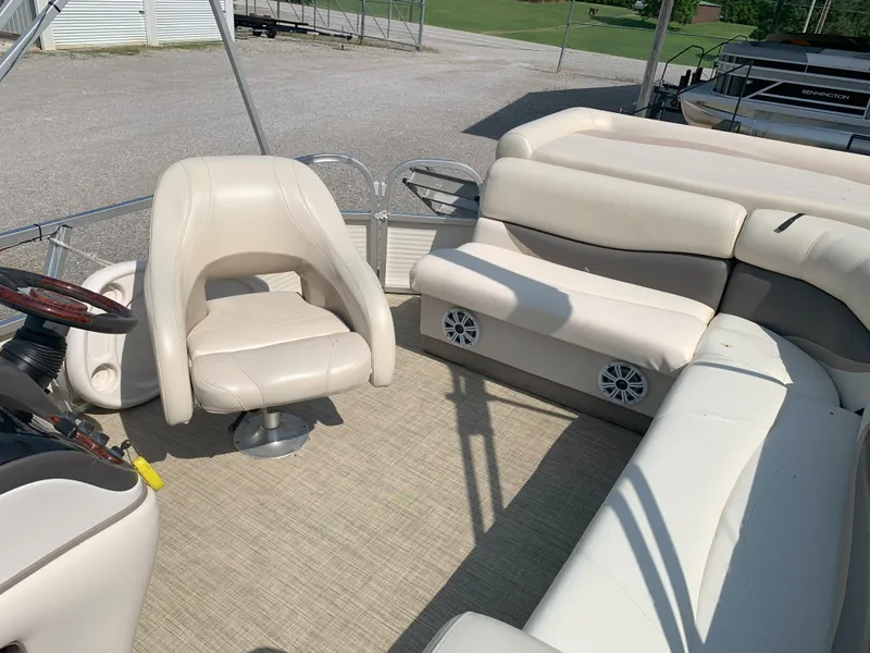 Slide: The Image of 2007 Sun Tracker Party Barge 22 interior with beige seating and steering wheel. - 7