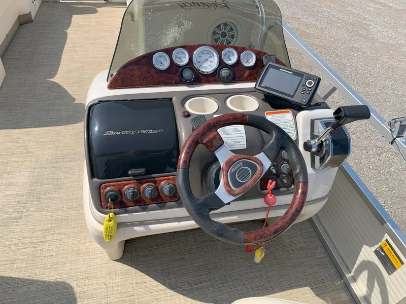 Slide: The Image of 2007 Sun Tracker Party Barge 22 dashboard with steering wheel and controls. - 8