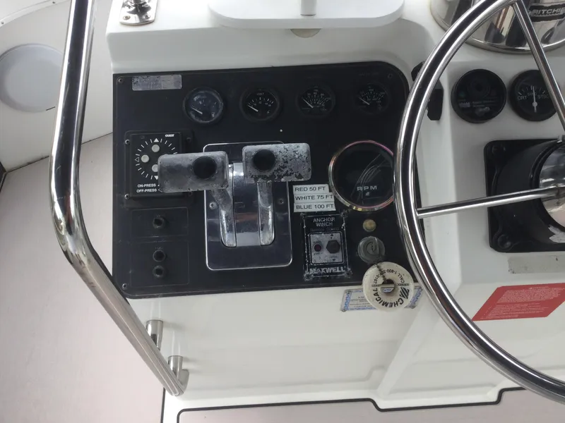 Slide: The Image of 1995 Carver 430 Cockpit Motor Yacht control panel with steering wheel and gauges. - 10
