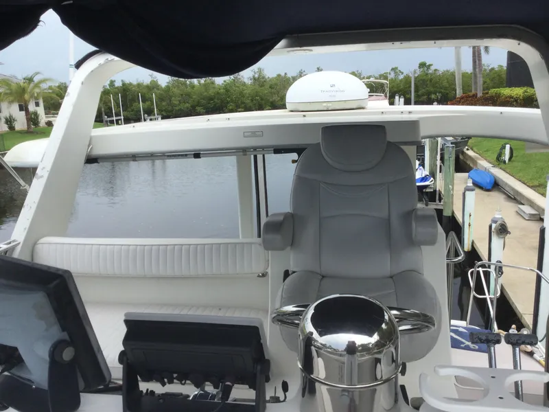 Slide: The Image of 1995 Carver 430 Cockpit Motor Yacht helm with modern navigation equipment and comfortable seating. - 12
