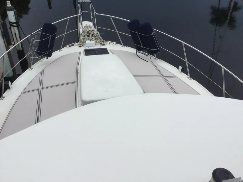 Slide: The Image of 1995 Carver 430 Cockpit Motor Yacht deck with railing and mooring ropes. - 14