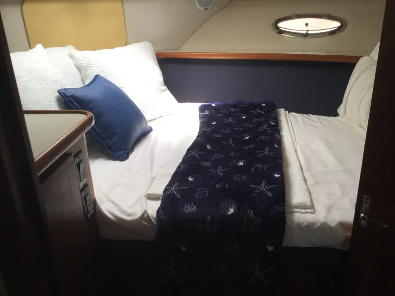 Slide: The Image of Cozy bedroom in 1995 Carver 430 Cockpit Motor Yacht with nautical-themed bedding. - 17