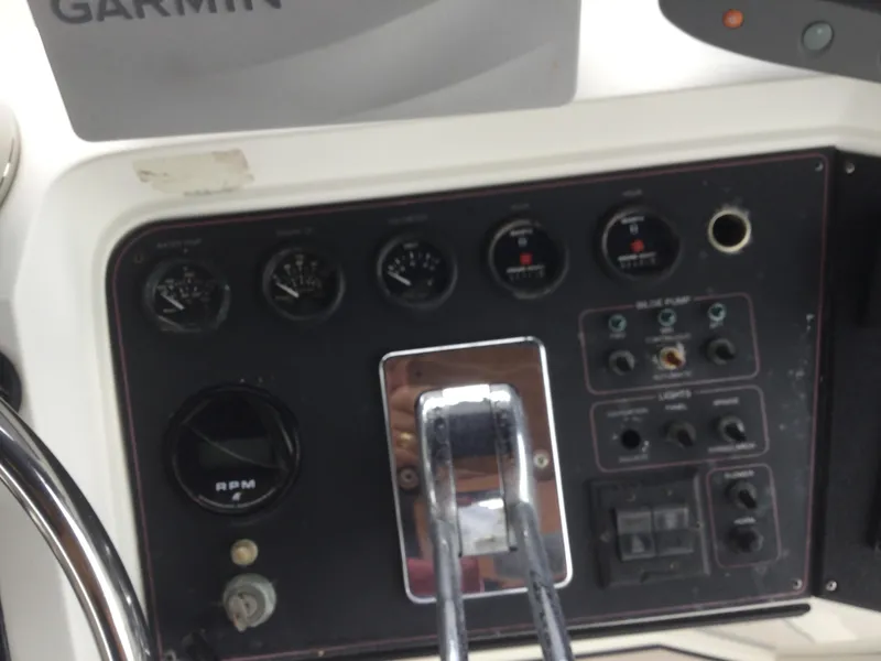 Slide: The Image of Control panel of a 1995 Carver 430 Cockpit Motor Yacht with gauges and switches. - 21