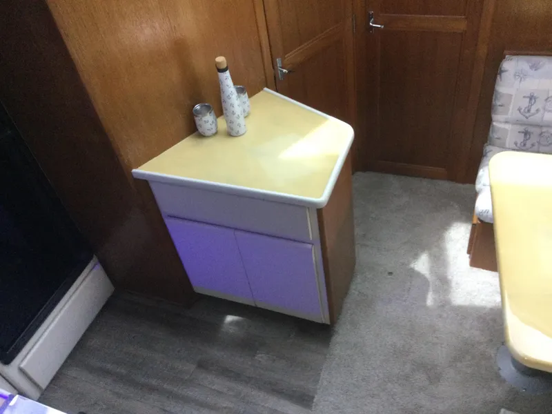 Slide: The Image of Interior of 1995 Carver 430 Cockpit Motor Yacht with corner cabinet and seating area. - 26