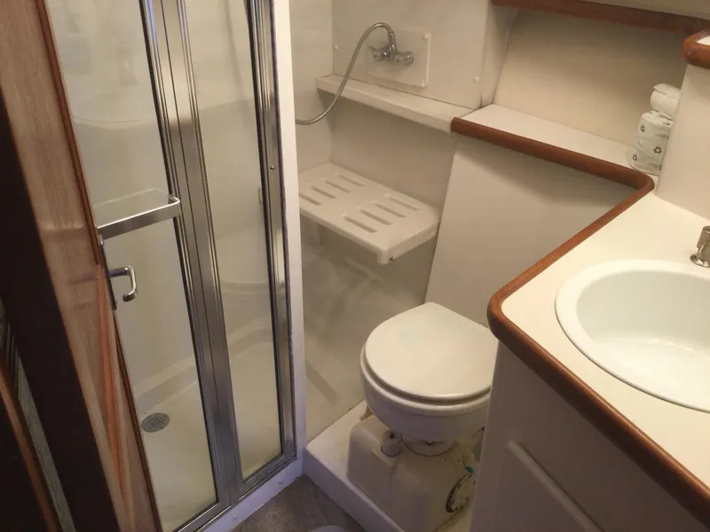 Slide: The Image of Bathroom in 1995 Carver 430 Cockpit Motor Yacht with shower, toilet, and sink. - 34