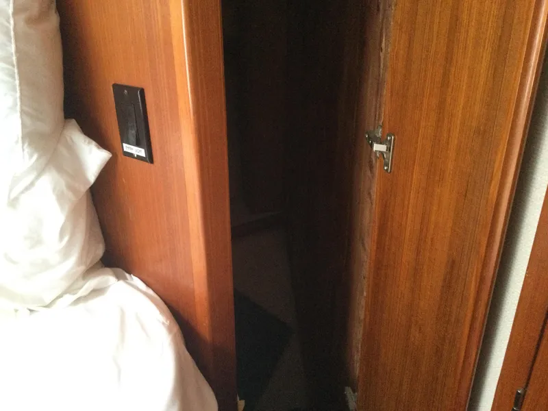 Slide: The Image of Interior of 1995 Carver 430 Cockpit Motor Yacht with wooden door and bedding. - 37