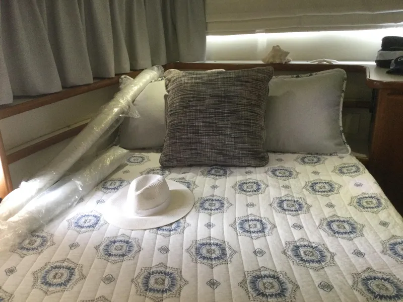 Slide: The Image of Cozy bedroom in 1995 Carver 430 Cockpit Motor Yacht with patterned bedding and pillows. - 42