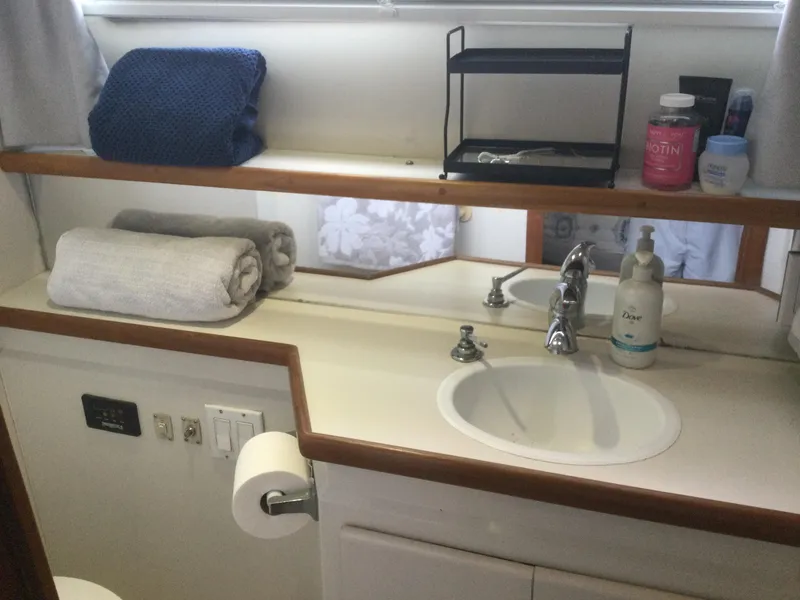 Slide: The Image of Bathroom vanity in 1995 Carver 430 Cockpit Motor Yacht with towels and toiletries. - 45