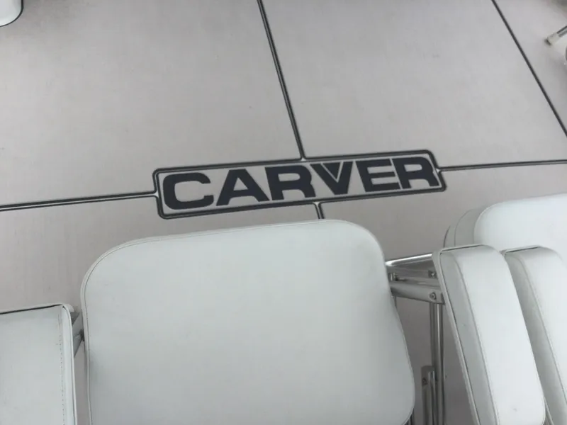 Slide: The Image of 1995 Carver 430 Cockpit Motor Yacht interior with white seating and logo. - 49