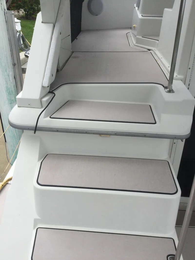 Slide: The Image of Staircase on 1995 Carver 430 Cockpit Motor Yacht, featuring clean white design. - 8