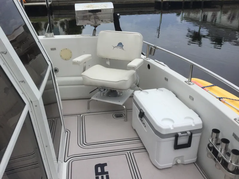 Slide: The Image of 1995 Carver 430 Cockpit Motor Yacht deck with chair and cooler. - 3