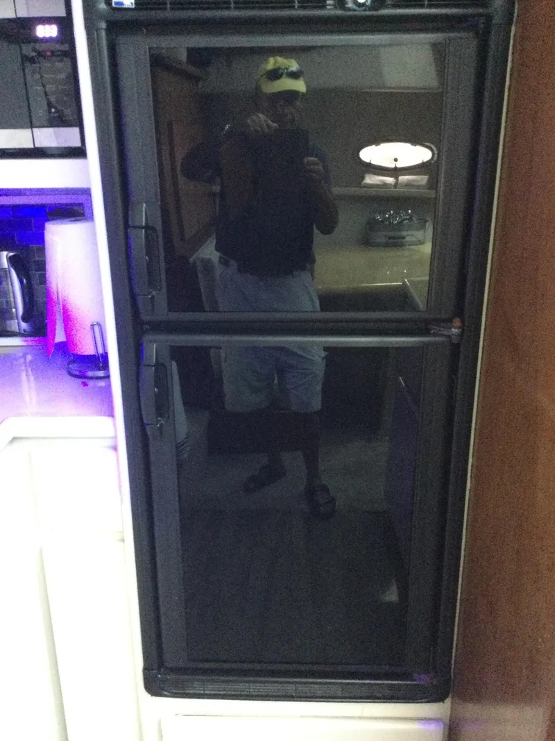Slide: The Image of Reflection on a refrigerator door inside a 1995 Carver 430 Cockpit Motor Yacht. - 31
