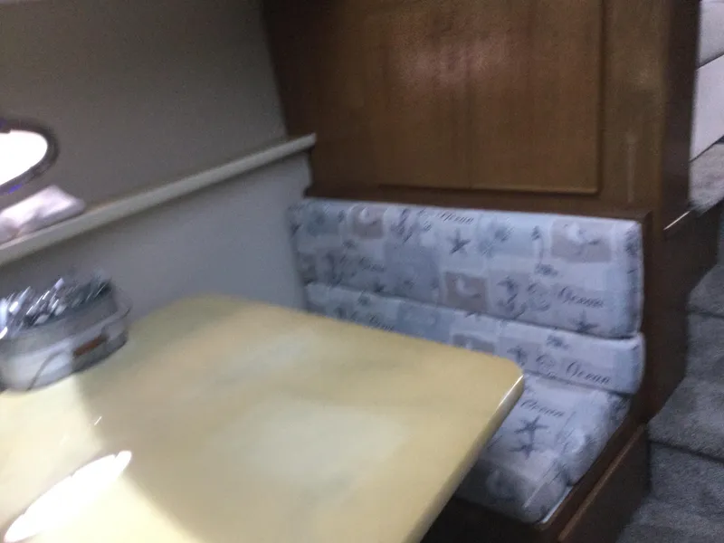 Slide: The Image of Interior of 1995 Carver 430 Cockpit Motor Yacht with dining area and cushioned seating. - 40