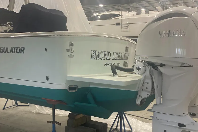 Slide: The Image of 2023 Regulator 28 Forward Seating boat with Yamaha engine in a storage facility. - 10