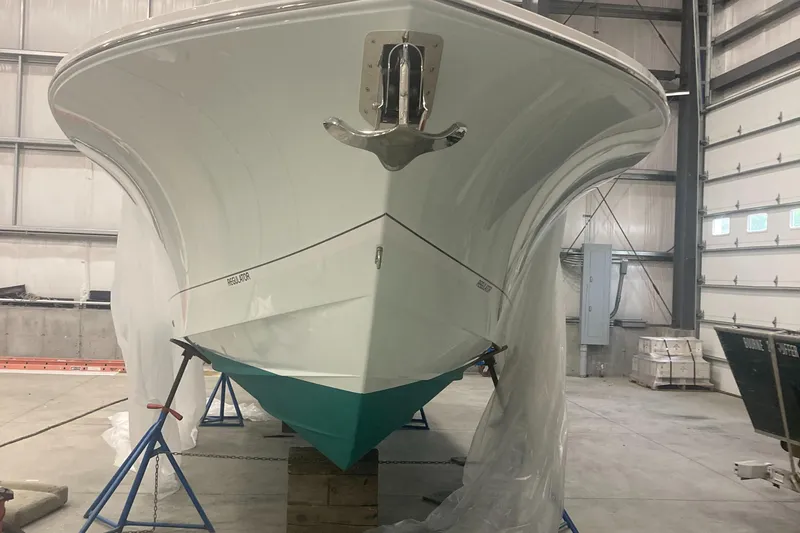 Slide: The Image of 2023 Regulator 28 Forward Seating boat in a warehouse, viewed from the front. - 3