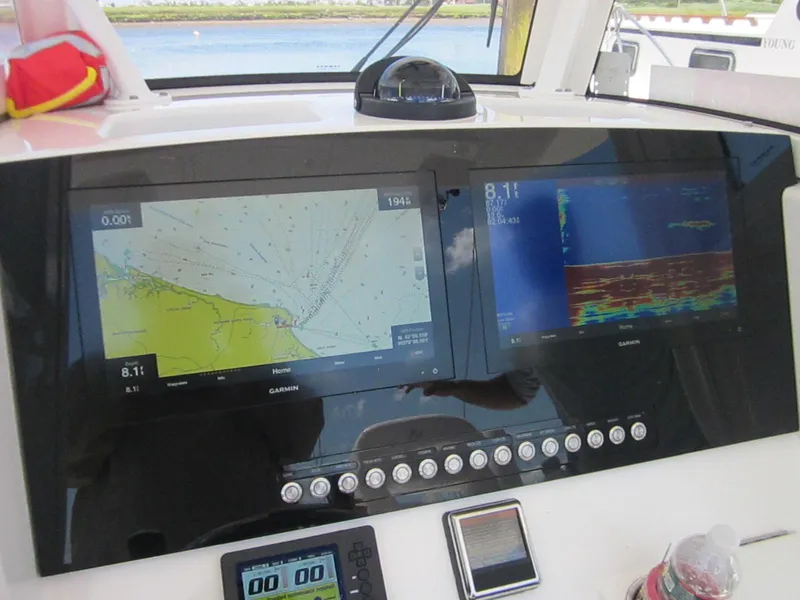 Slide: The Image of 2023 Regulator 28 Forward Seating boat dashboard with navigation and sonar displays. - 5