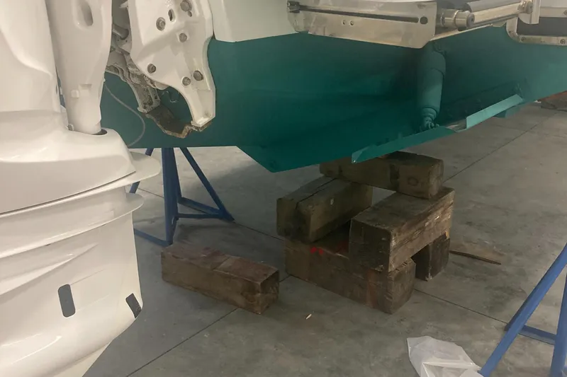 Slide: The Image of 2023 Regulator 28 Forward Seating boat on blocks in a workshop. - 6