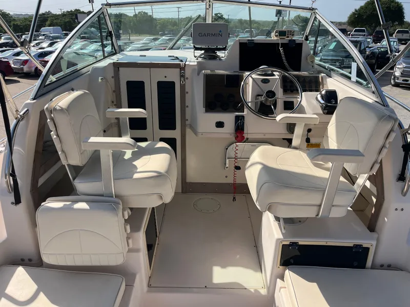 Slide: The Image of Interior of a 1997 Grady-White 232 Gulfstream boat with dual captain chairs and steering console. - 11