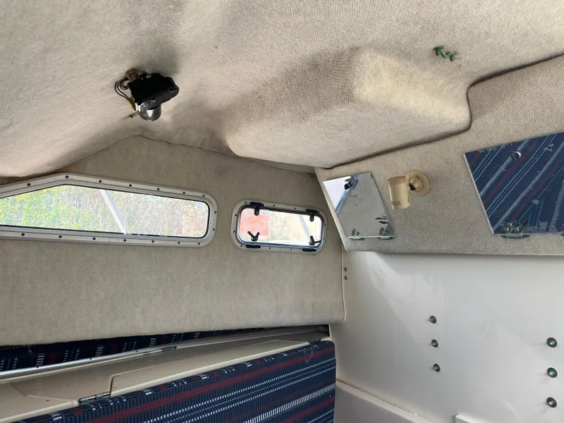 Slide: The Image of Interior cabin of 1997 Grady-White 232 Gulfstream boat with windows and seating. - 17