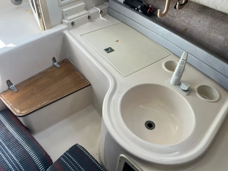 Slide: The Image of Interior of 1997 Grady-White 232 Gulfstream boat with sink and seating area. - 20