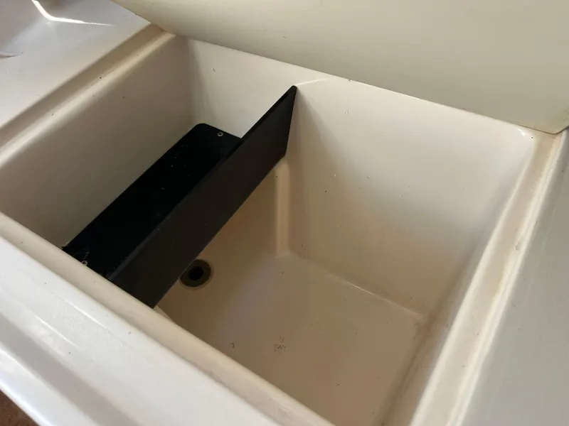 Slide: The Image of 1997 Grady-White 232 Gulfstream boat compartment interior, featuring a clean, white storage area. - 22