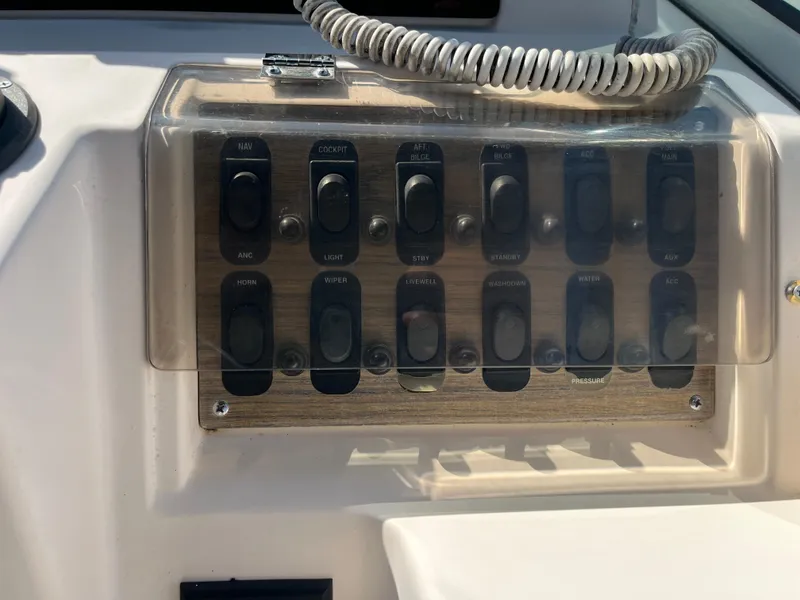 Slide: The Image of Control panel of a 1997 Grady-White 232 Gulfstream boat with labeled switches. - 25