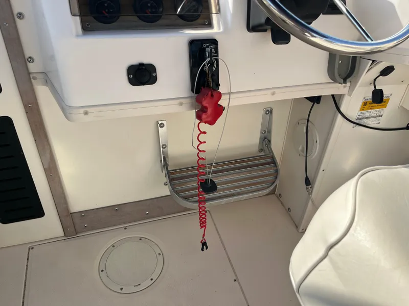 Slide: The Image of Interior of a 1997 Grady-White 232 Gulfstream boat showing steering wheel and controls. - 28