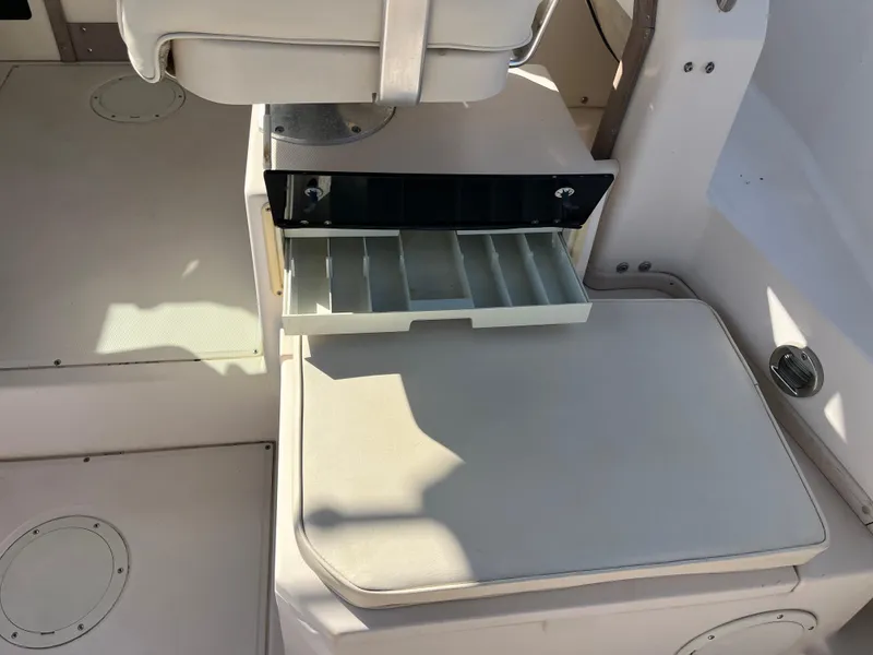 Slide: The Image of 1997 Grady-White 232 Gulfstream boat interior with open storage compartment. - 31