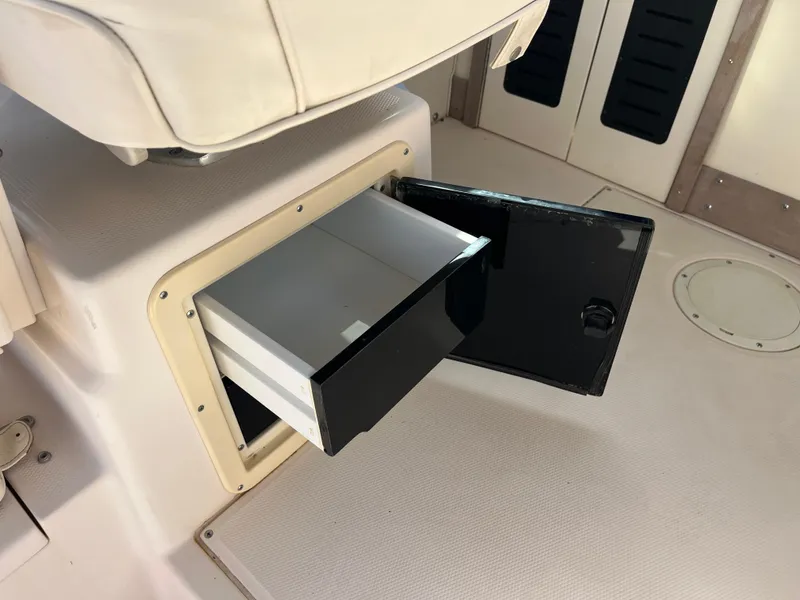 Slide: The Image of Open storage compartment on 1997 Grady-White 232 Gulfstream boat interior. - 32