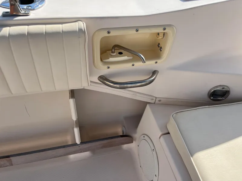 Slide: The Image of Interior of 1997 Grady-White 232 Gulfstream boat, featuring seating and storage compartment. - 34