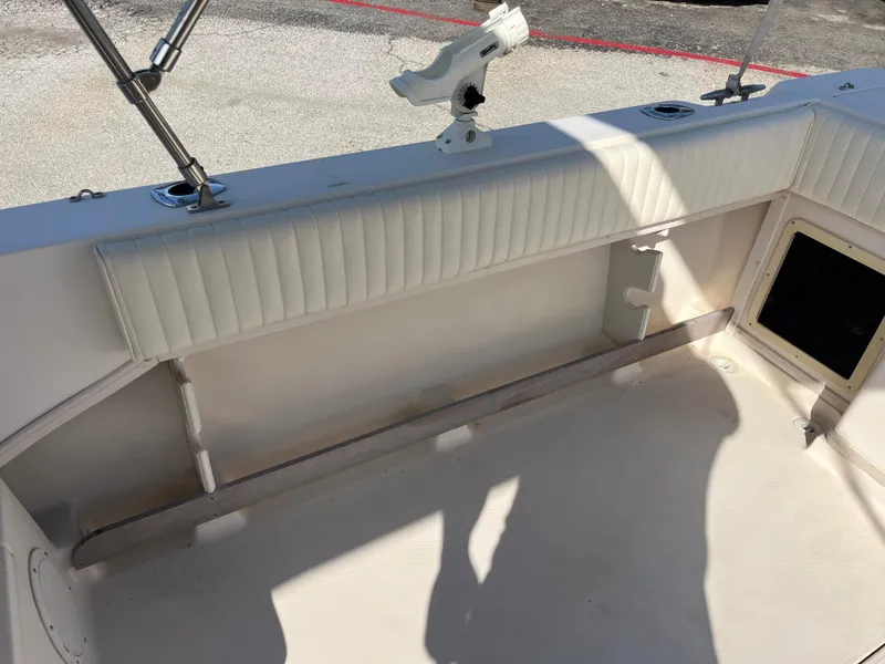 Slide: The Image of Interior of a 1997 Grady-White 232 Gulfstream boat, featuring seating and rod holder. - 36
