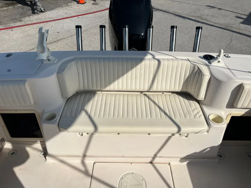 Slide: The Image of 1997 Grady-White 232 Gulfstream boat interior with cushioned seating and rod holders. - 37