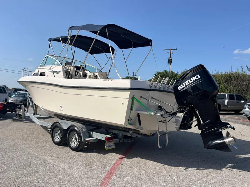 Slide: The Image of 1997 Grady-White 232 Gulfstream boat on trailer with Suzuki outboard motor. - 4