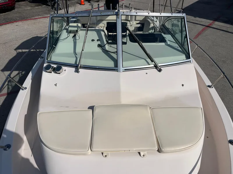 Slide: The Image of 1997 Grady-White 232 Gulfstream boat with windshield and cushioned bow seating. - 45