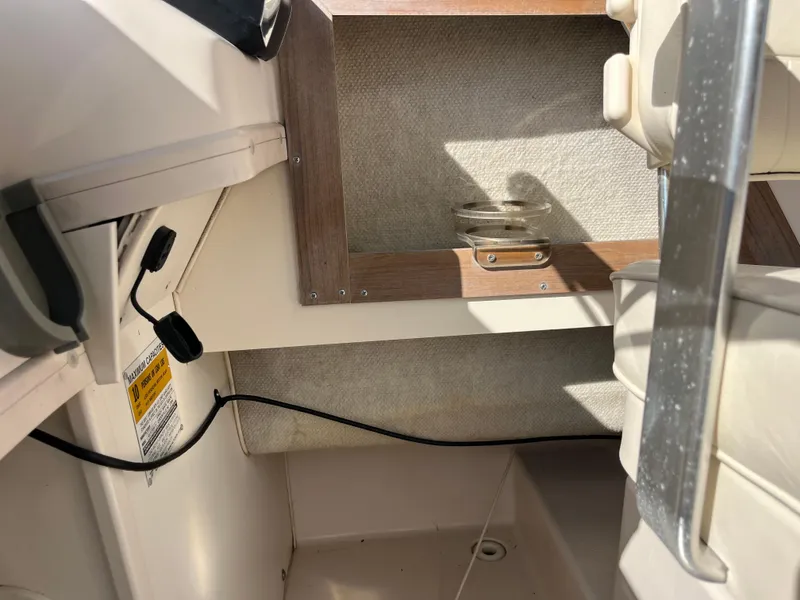 Slide: The Image of Interior of a 1997 Grady-White 232 Gulfstream boat, featuring seating and storage. - 50