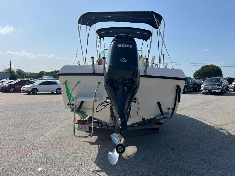 Slide: The Image of 1997 Grady-White 232 Gulfstream boat with Suzuki outboard motor in a parking lot. - 7