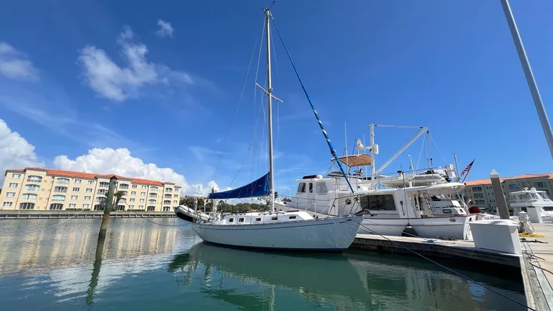 Slide: The Image of 1976 Endeavour 32' Sloop docked at marina under clear blue sky. - 1
