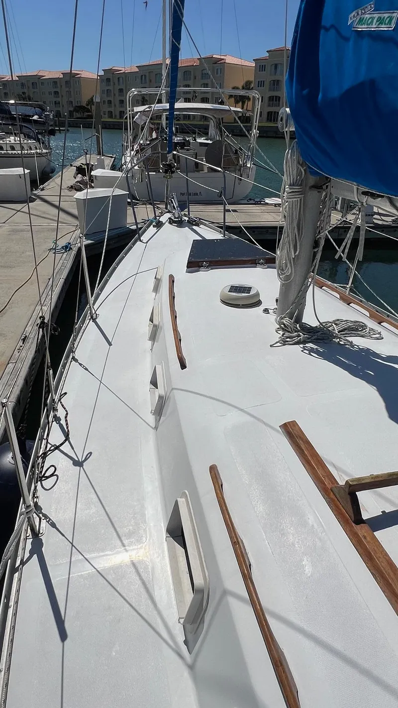 Slide: The Image of 1976 Endeavour 32' Sloop docked at marina, showcasing deck and rigging. - 14