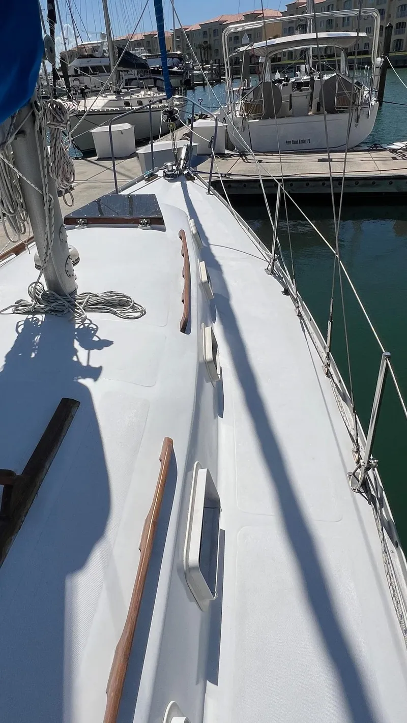 Slide: The Image of 1976 Endeavour 32' Sloop docked in marina, showcasing deck and rigging. - 15