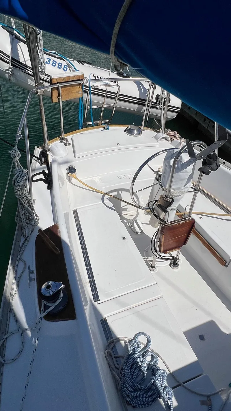 Slide: The Image of 1976 Endeavour 32' Sloop sailboat deck with ropes and winch in marina. - 16