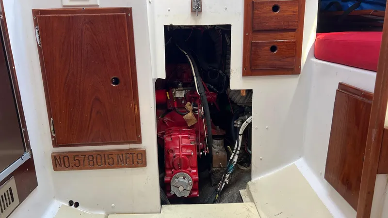 Slide: The Image of Interior view of a 1976 Endeavour 32' Sloop engine compartment with wooden cabinetry. - 45