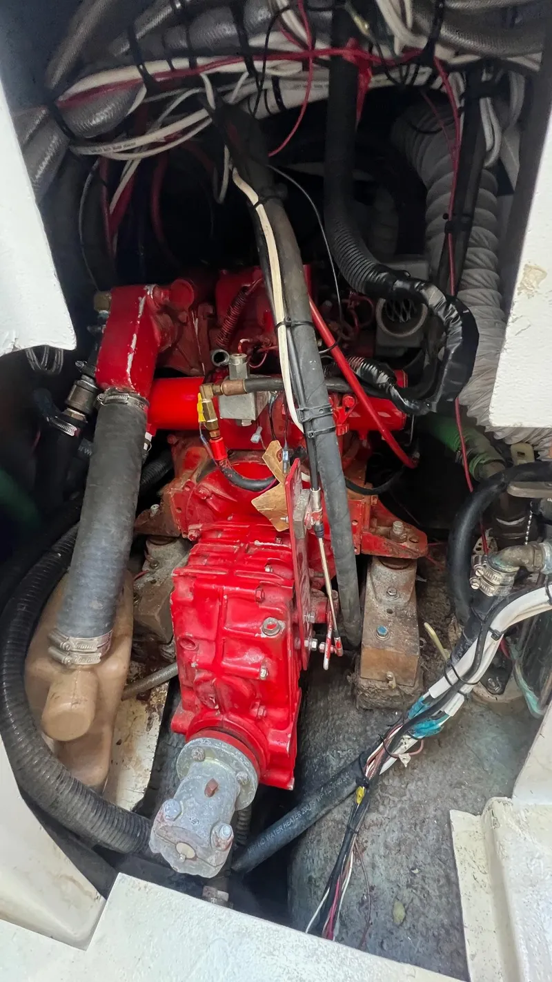 Slide: The Image of Engine compartment of a 1976 Endeavour 32' Sloop with visible red engine components. - 46