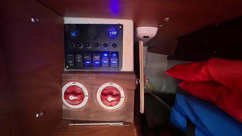 Slide: The Image of Electrical panel and switches inside a 1976 Endeavour 32' Sloop sailboat cabin. - 47