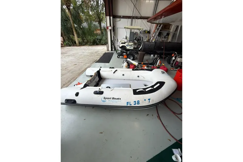 Slide: The Image of Inflatable sport boat in a garage, near a 1976 Endeavour 32' Sloop. - 49