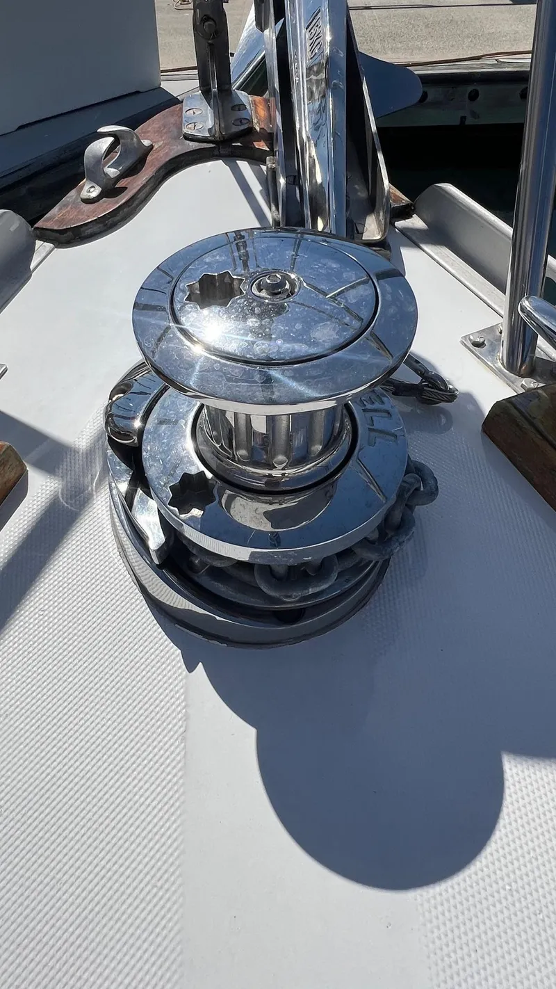 Slide: The Image of Chrome winch on 1976 Endeavour 32' Sloop deck, reflecting sunlight. - 9
