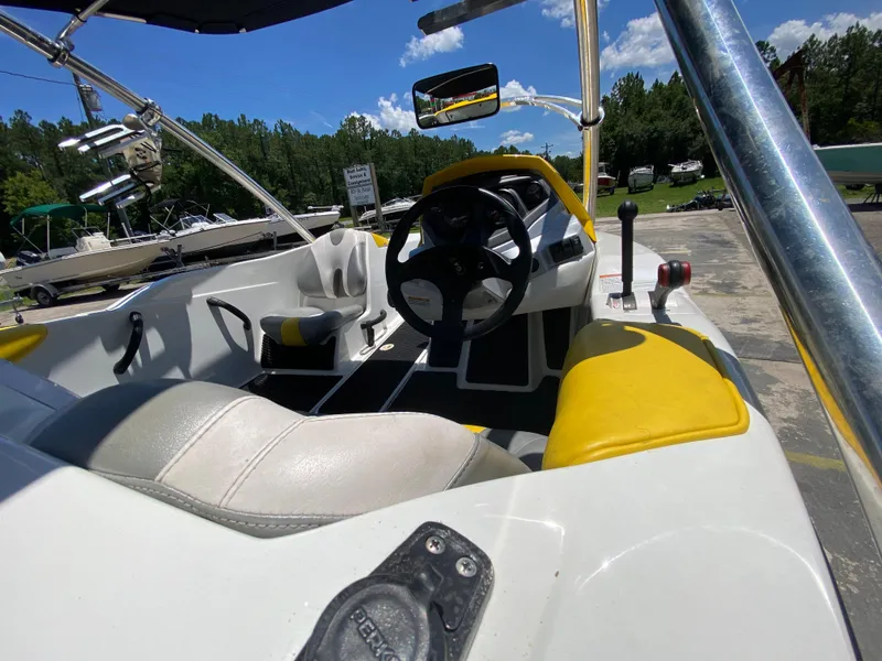 Slide: The Image of 2006 Sea-Doo Sportster boat interior with yellow and white seating, steering wheel, and controls. - 10