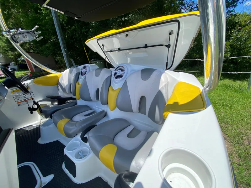 Slide: The Image of 2006 Sea-Doo Sportster boat interior with yellow and gray seating, open storage compartment. - 4