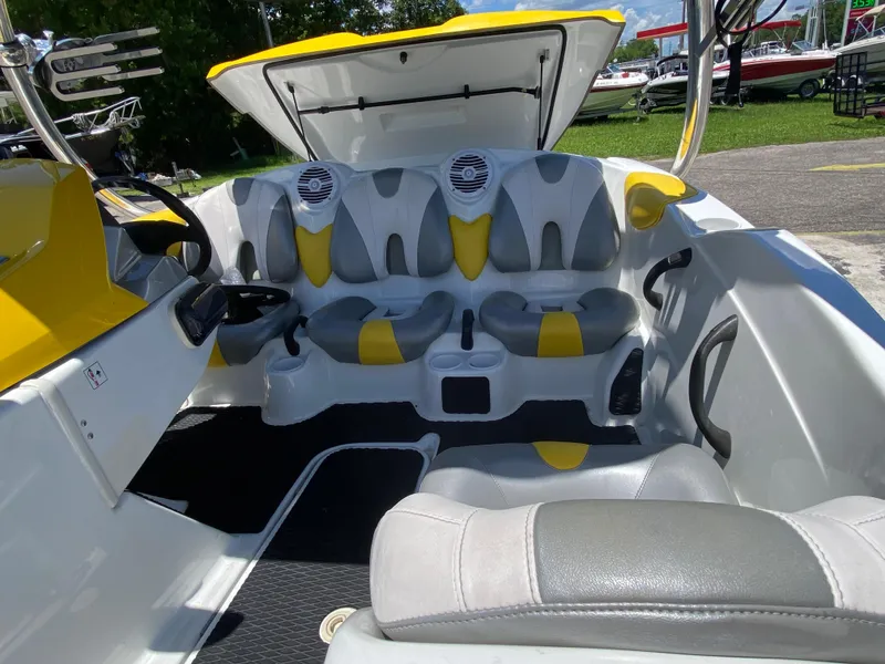 Slide: The Image of 2006 Sea-Doo Sportster boat interior with yellow and gray seating, open storage compartment. - 6