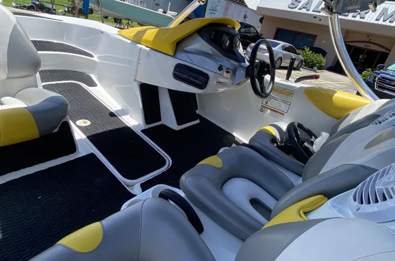 Slide: The Image of 2006 Sea-Doo Sportster boat interior with yellow and gray seating, steering wheel, and dashboard. - 7